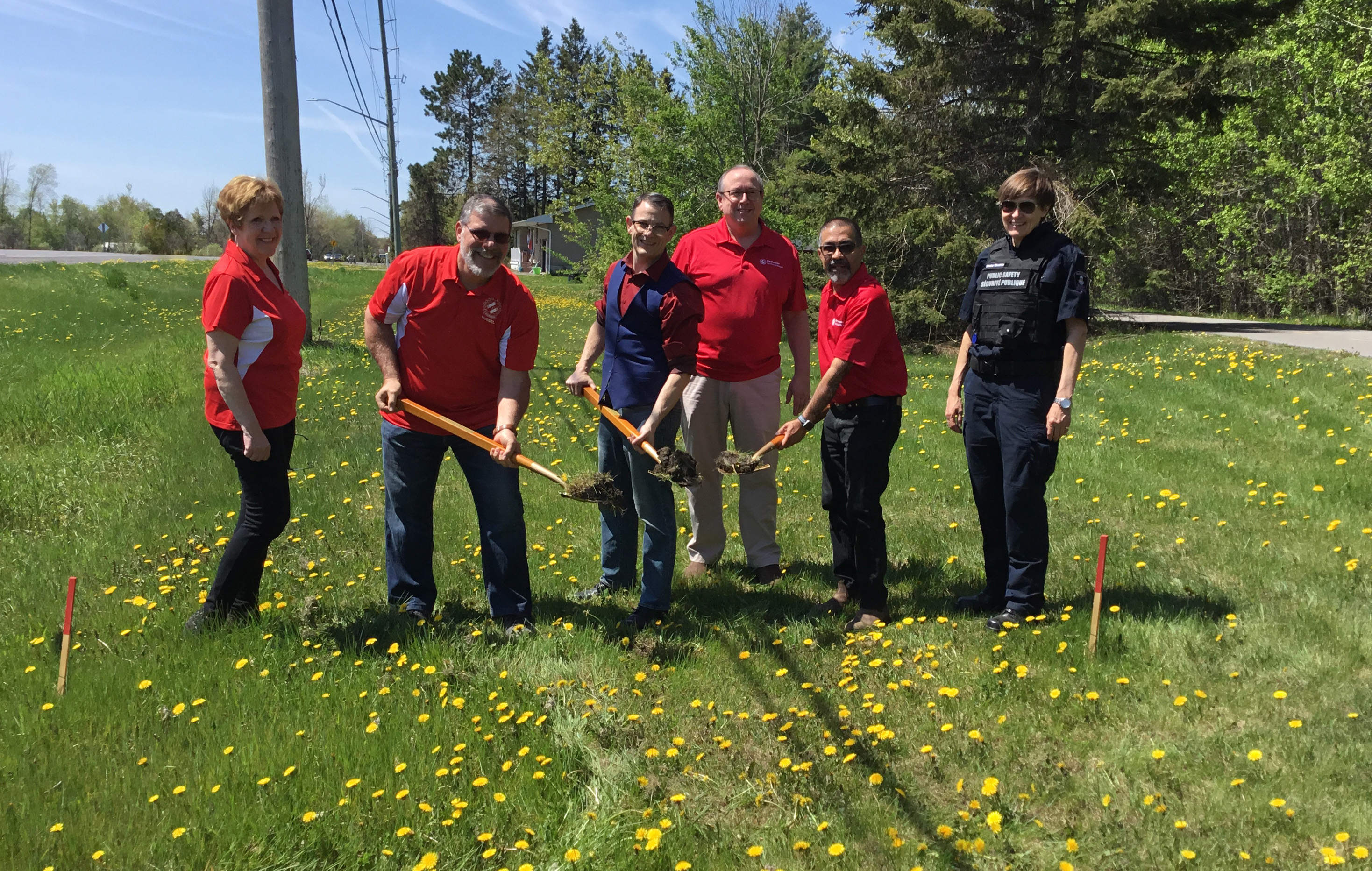 Committee members with shovels