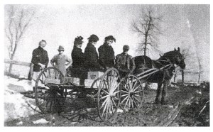 Three Women Standing on the Back of a Horse and Carriage