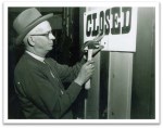 Man Hanging a Closed Sign