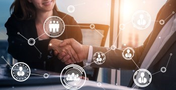 Woman shaking hands with a man in an office