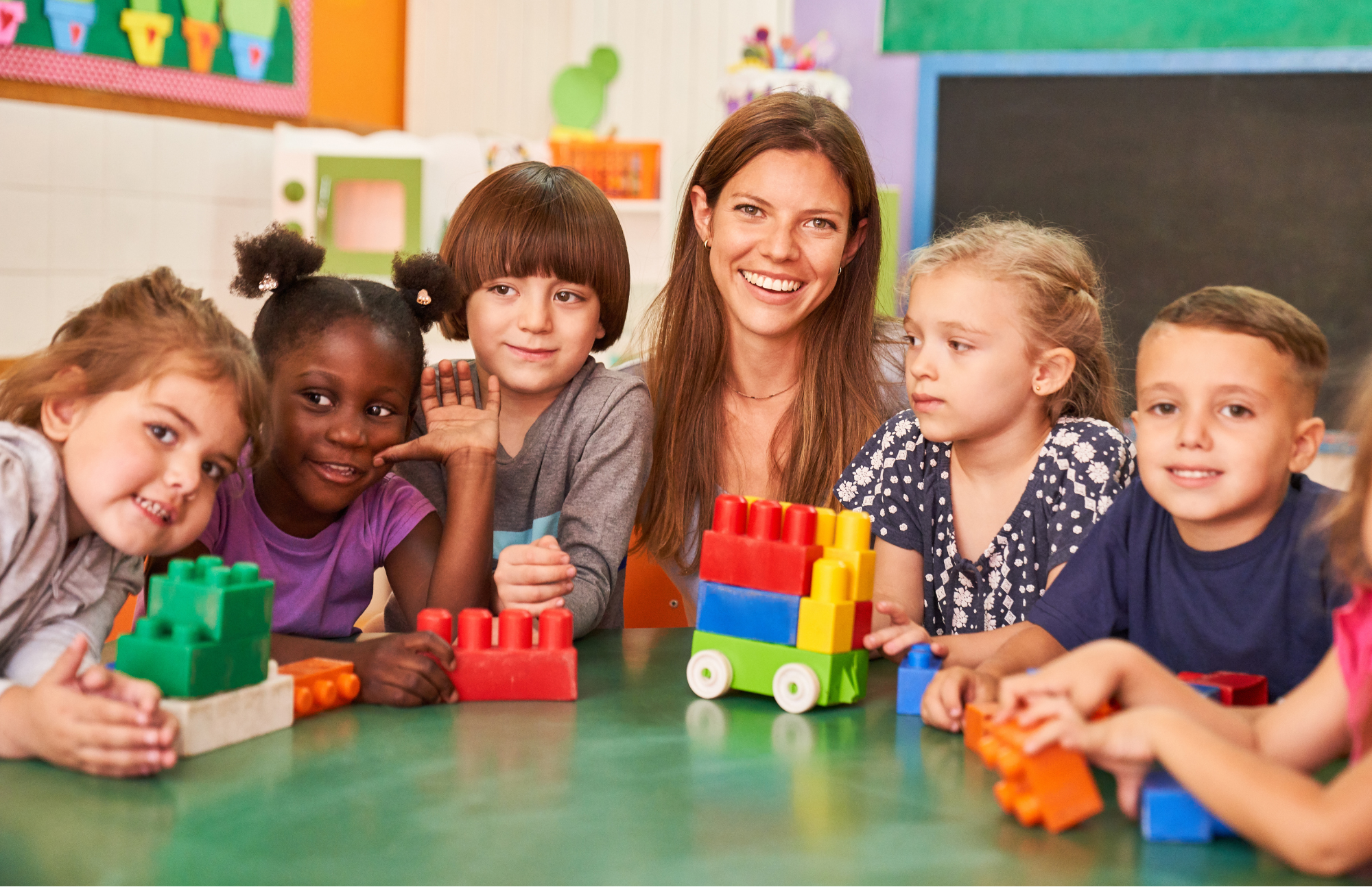 four kids on the floor smiling