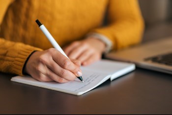 Person writing on a paper